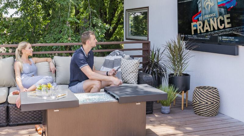 Couple watching TV outside on a deck